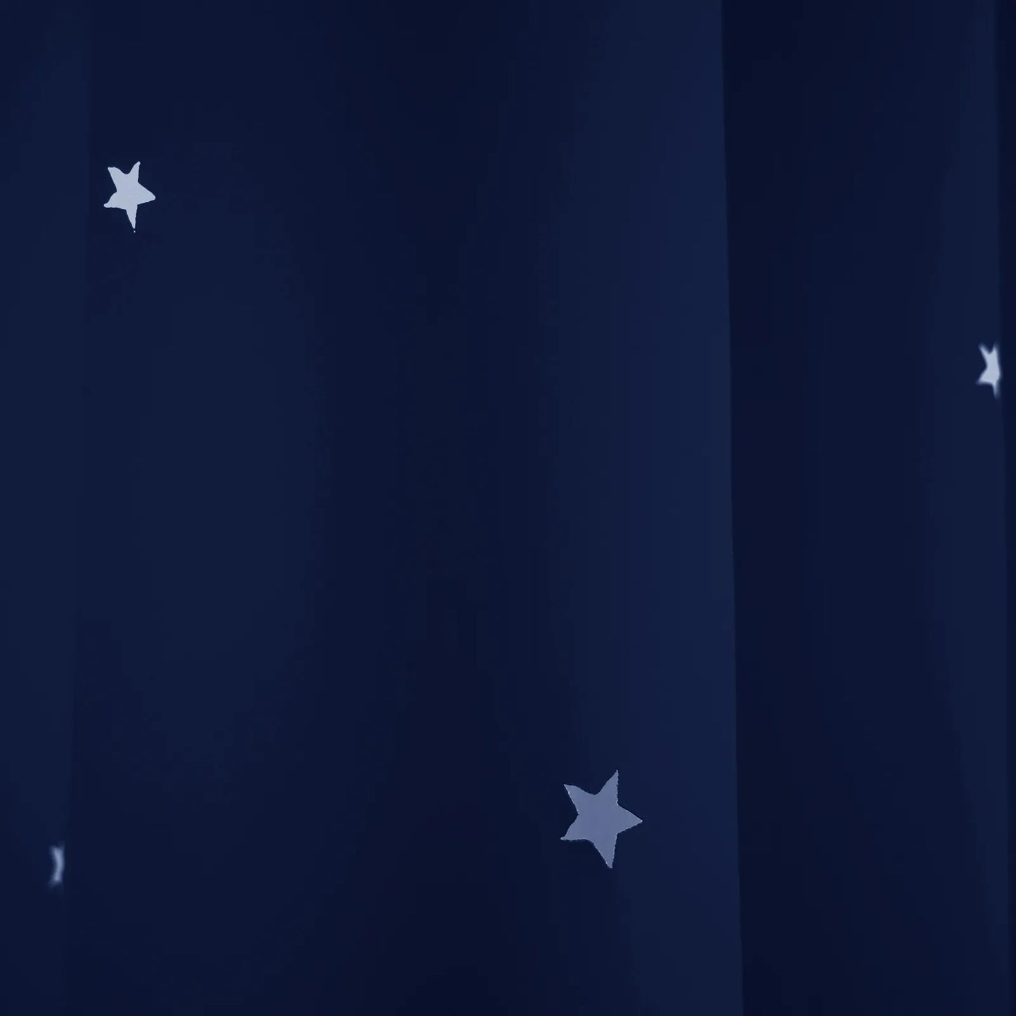 Blackout curtain with cut-out stars and overlay design