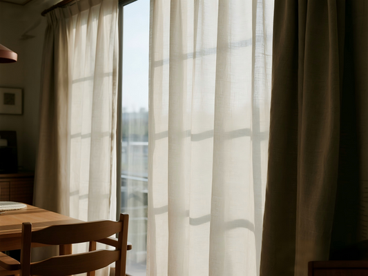 Freshly cleaned linen curtains hanging in bright sunlight