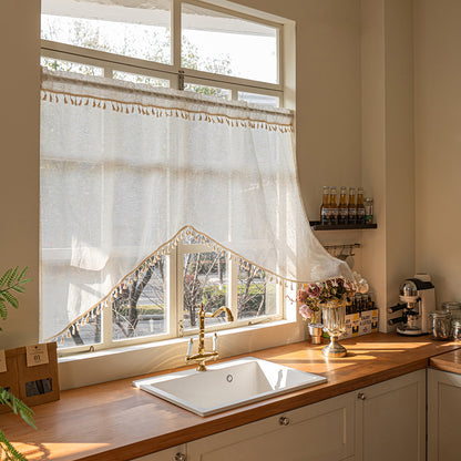 Arched cafe curtain in a linen blend with tassels in a country style