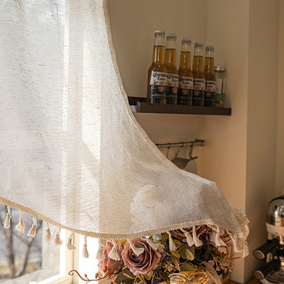 Arched cafe curtain in a linen blend with tassels in a country style