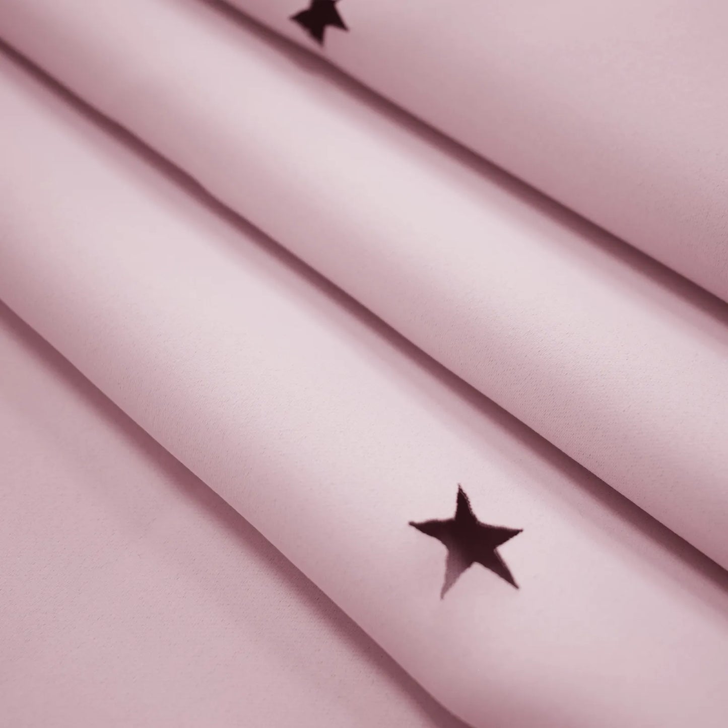 Blackout curtain with cut-out stars and overlay design