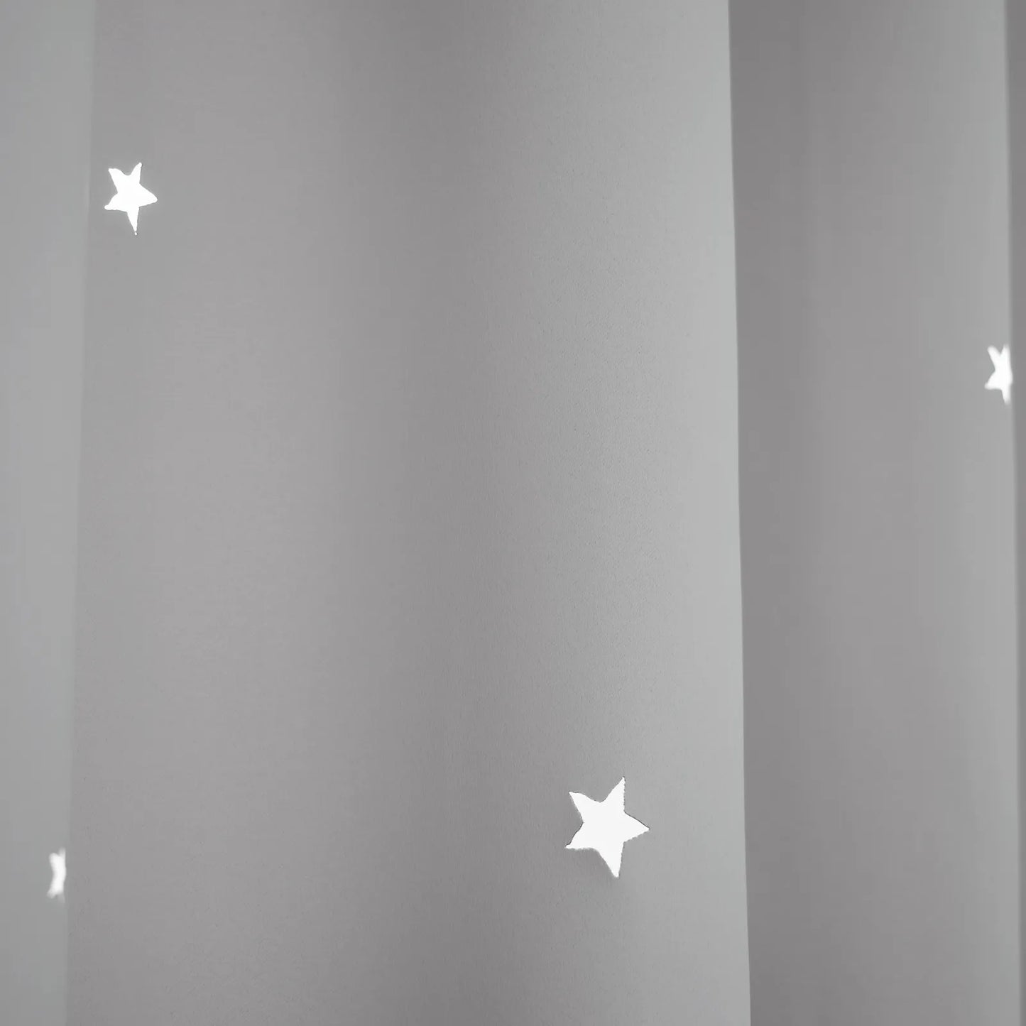 Blackout curtain with cut-out stars and overlay design