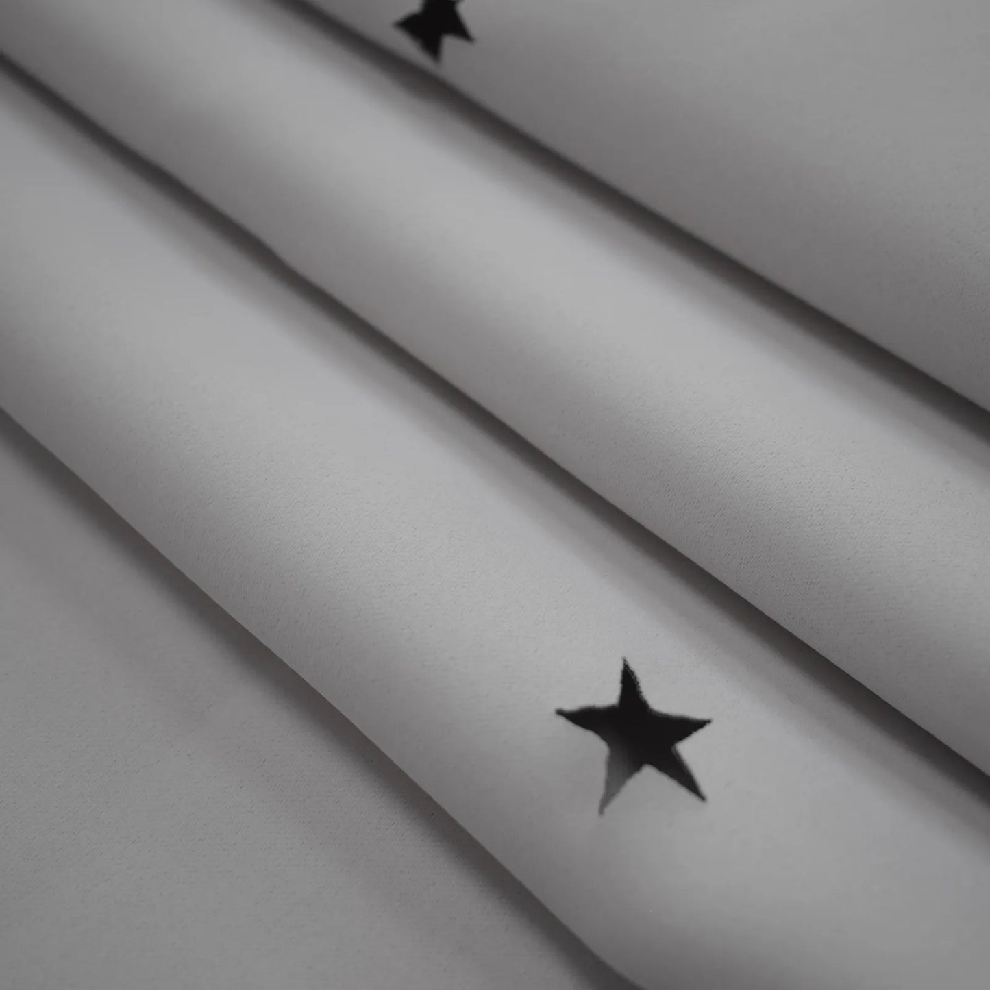 Blackout curtain with cut-out stars and overlay design