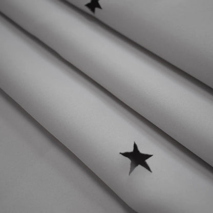 Blackout curtain with cut-out stars and overlay design