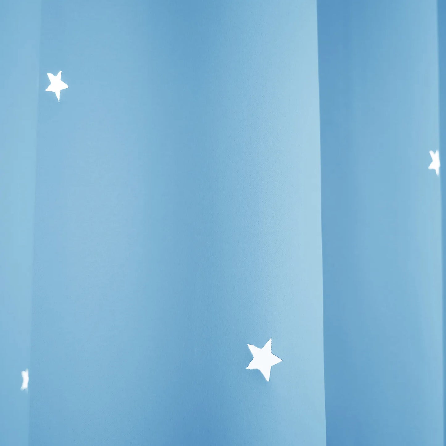 Blackout curtain with cut-out stars and overlay design