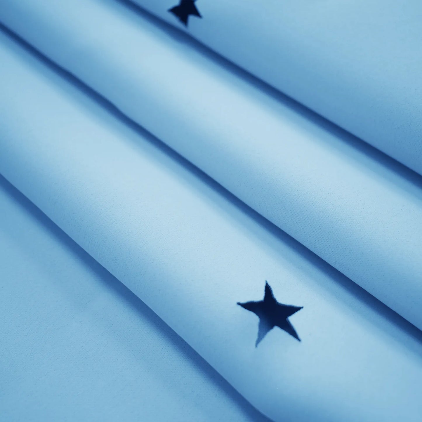 Blackout curtain with cut-out stars and overlay design