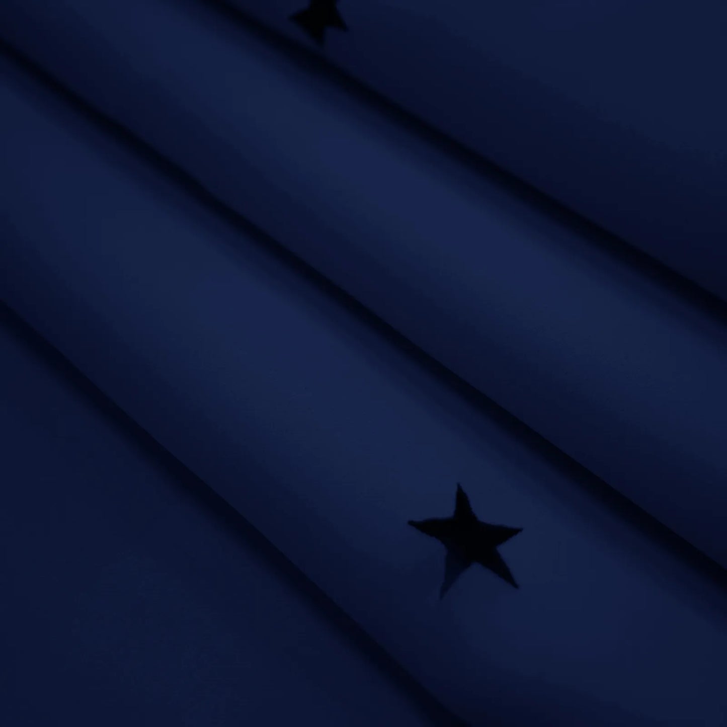 Blackout curtain with cut-out stars and overlay design